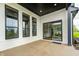 Covered back porch with brick siding and a view into the kitchen at 16457 Gleneagles Ct, Noblesville, IN 46060