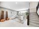 Spacious finished basement with an office area, including a large window, sleek desk, and stairs at 16457 Gleneagles Ct, Noblesville, IN 46060