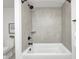 Bathroom features a shower and tub combo with tiled walls and black fixtures at 16457 Gleneagles Ct, Noblesville, IN 46060
