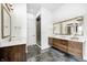 Elegant bathroom with dual floating vanities, stylish mirrors and a glass enclosed shower at 16457 Gleneagles Ct, Noblesville, IN 46060