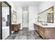 Elegant bathroom with dual floating vanities, stylish mirrors and tile flooring at 16457 Gleneagles Ct, Noblesville, IN 46060