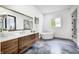 Elegant bathroom with a floating vanity, stylish mirror and a soaking tub at 16457 Gleneagles Ct, Noblesville, IN 46060