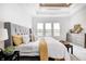 This bedroom features a tray ceiling, many windows, and a lovely gray upholstered headboard at 16457 Gleneagles Ct, Noblesville, IN 46060