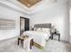 This bedroom features a tray ceiling, many windows, and a lovely gray upholstered headboard at 16457 Gleneagles Ct, Noblesville, IN 46060