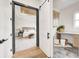 View into a beautifully decorated bedroom through sliding barn doors, features light, bright, modern decor at 16457 Gleneagles Ct, Noblesville, IN 46060