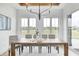 The dining room showcases natural light, complementing the modern chandelier and wood table set at 16457 Gleneagles Ct, Noblesville, IN 46060