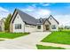Beautiful home exterior with stone accents, three-car garage, and manicured lawn on a sunny day at 16457 Gleneagles Ct, Noblesville, IN 46060
