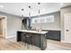 Modern kitchen island with marble countertop, stylish pendant lighting, and comfortable bar seating at 16457 Gleneagles Ct, Noblesville, IN 46060