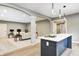 Open-concept design showcases a stylish kitchen with bar seating flowing into a cozy living area at 16457 Gleneagles Ct, Noblesville, IN 46060