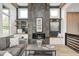 Comfortable living room featuring built-in shelving, modern fireplace, and wood beams at 16457 Gleneagles Ct, Noblesville, IN 46060