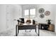 Inviting home office with lots of natural light, neutral décor, and a spacious desk to complete your tasks at 16457 Gleneagles Ct, Noblesville, IN 46060