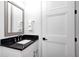 Elegant powder room with a marble countertop, modern faucet, and stylish vanity provides a charming retreat at 16457 Gleneagles Ct, Noblesville, IN 46060