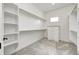 Spacious walk-in closet boasts custom shelving, drawers, and ample storage for an organized wardrobe at 16457 Gleneagles Ct, Noblesville, IN 46060