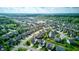 Overhead shot of residential homes in a verdant community featuring tree-lined streets and proximity to a serene pond at 1662 Cascade Dr, Greenwood, IN 46143