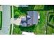 Aerial roof view of home's new roof, backyard with mature landscaping, and adjacent street in a Gathering neighborhood at 1662 Cascade Dr, Greenwood, IN 46143