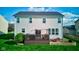 The backyard includes a wooden deck, a well-kept lawn, and manicured garden beds, offering a serene retreat at 1662 Cascade Dr, Greenwood, IN 46143