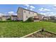 View of backyard featuring two-story home, lawn and wooden deck at 1662 Cascade Dr, Greenwood, IN 46143