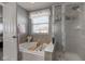 Bathroom with a large tub with a window with blinds and a sliding door shower at 1662 Cascade Dr, Greenwood, IN 46143