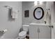 Cozy bathroom with oval mirror, vanity with storage, toilet and towel rack at 1662 Cascade Dr, Greenwood, IN 46143