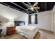 Cozy bedroom with modern ceiling fan, large window, and carpeted floor at 1662 Cascade Dr, Greenwood, IN 46143