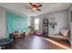 Bonus room with a wood floor, wall tapestry, a ceiling fan, plants, and exercise equipment at 1662 Cascade Dr, Greenwood, IN 46143