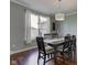 Dining room with large window and a wooden table set for dinner at 1662 Cascade Dr, Greenwood, IN 46143