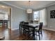 Cozy dining room with wood floors, modern lighting, and view to the kitchen at 1662 Cascade Dr, Greenwood, IN 46143