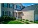 Close up of home's entryway showcasing a well-maintained lawn, brick facade, and inviting front door with sidelights at 1662 Cascade Dr, Greenwood, IN 46143