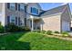A charming two-story brick home with professionally landscaped front yard and inviting front porch at 1662 Cascade Dr, Greenwood, IN 46143