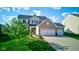 Charming two-story home with a well-manicured lawn, attached three car garage, and a inviting front entrance at 1662 Cascade Dr, Greenwood, IN 46143