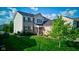 Two-story home with brick and vinyl siding, well-maintained lawn, and manicured landscaping adding to its curb appeal at 1662 Cascade Dr, Greenwood, IN 46143