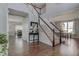 Spacious foyer with hardwood floors and elegant staircase leading to the upper level at 1662 Cascade Dr, Greenwood, IN 46143