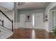 Elegant foyer featuring hardwood floors, soaring ceilings, and a view of the front entry at 1662 Cascade Dr, Greenwood, IN 46143
