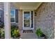 A welcoming front entrance with decorative wreath and potted plants, and brick facade at 1662 Cascade Dr, Greenwood, IN 46143