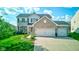 Attractive two-story home with a brick facade, well-manicured lawn, and a spacious driveway at 1662 Cascade Dr, Greenwood, IN 46143