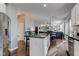 Open-concept kitchen with center island and seating, flowing into the living room with built-in shelves at 1662 Cascade Dr, Greenwood, IN 46143