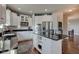 Modern kitchen features white cabinetry, stainless steel appliances, and a large island with bar seating at 1662 Cascade Dr, Greenwood, IN 46143