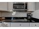 Kitchen cooktop, oven, microwave, and coffee maker against a white subway tile backsplash at 1662 Cascade Dr, Greenwood, IN 46143