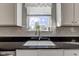 Close up of kitchen sink and window with view, features white subway tile backsplash at 1662 Cascade Dr, Greenwood, IN 46143