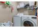 The laundry room features a modern washer and dryer and shelving for ample storage at 1662 Cascade Dr, Greenwood, IN 46143