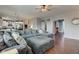 Open-concept living room with a large sectional sofa and view into kitchen at 1662 Cascade Dr, Greenwood, IN 46143