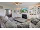 Cozy living room with a fireplace, built-in shelves, and an open view to the office at 1662 Cascade Dr, Greenwood, IN 46143