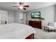 Spacious main bedroom with carpet floors, ceiling fan, and TV at 1662 Cascade Dr, Greenwood, IN 46143