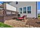 Comfortable patio space with lounge chair, small table, and access to the home's windows at 1662 Cascade Dr, Greenwood, IN 46143