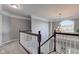 Carpeted staircase with views of a chandelier and an arched window at 1662 Cascade Dr, Greenwood, IN 46143