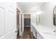 Bathroom with double sinks, white countertops, and walk-in closet at 16637 Brownstone Ct, Westfield, IN 46074