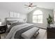 Comfortable bedroom featuring a ceiling fan, large window, and neutral décor at 16637 Brownstone Ct, Westfield, IN 46074
