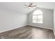 Unfurnished bedroom with vinyl flooring, vaulted ceiling, fan, and a bright window at 16637 Brownstone Ct, Westfield, IN 46074