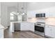 Modern kitchen with stainless steel appliances, white cabinetry, pendant lighting, and hardwood floors at 16637 Brownstone Ct, Westfield, IN 46074