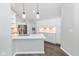 Bright kitchen boasts white cabinetry, a quartz countertop, and stainless steel appliances at 16637 Brownstone Ct, Westfield, IN 46074